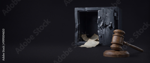 Judge gavel and empty opened broken metallic vault safe with brutal damages. Legal action for corporate funds or secrets stealing