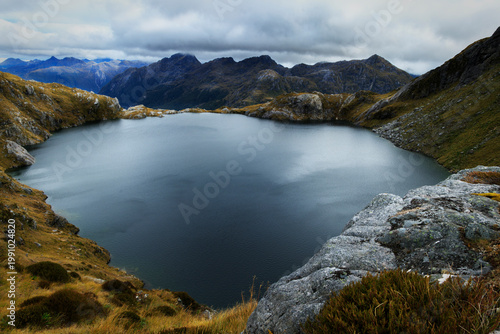 Steep Mountain Valley and Dark Lake in Fiordland