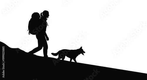Silhouette of a hiker and their dog walking along a ridge