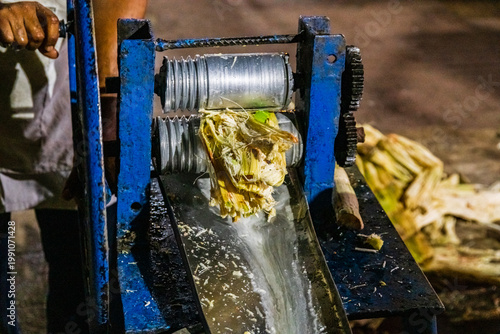 Preparing sugarcane juice at the Forodhani gardens in Stone town at night. Zanzibar, Tanzania