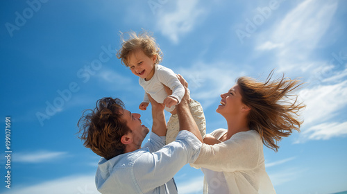 Happy parents lifting laughing child into air on sunny beach, joyful family bonding, love, lifestyle and carefree summer moment