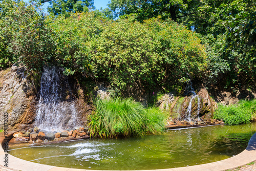 Photography Small artificial lake into which three waterfalls flow in a park near historic S