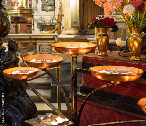 Votive candles burning inside the church of San Gennaro Naples ,  Italy.