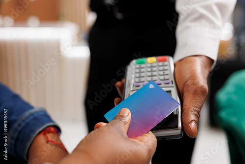 Cuadro en lienzo Close up of customer hand making NFC transaction holding credit card paying in hotel with contactless payment method