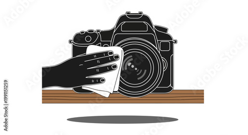 Hand wiping a professional DSLR camera with a soft cloth
