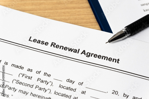 Legal document Lease Renewal Agreement on paper close up with pen