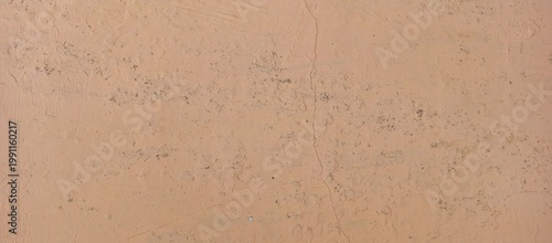 Old peach colored plaster wall texture background