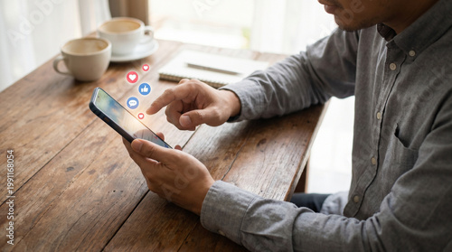 Social media marketing on smartphone, man using mobile phone app, digital engagement with like and heart icons