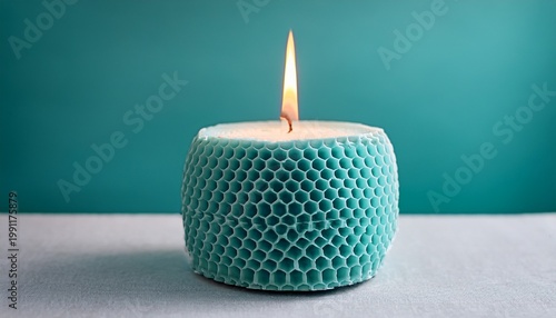 Turquoise Honeycomb Candle With Warm Flame On Minimal Background