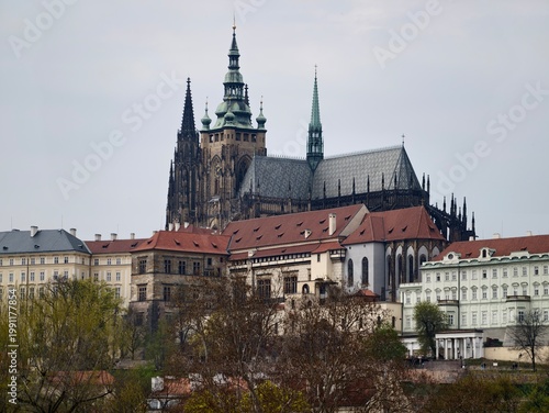 Vast cityscape with timeless architecture accented by lush springtime foliage and layered rooftops