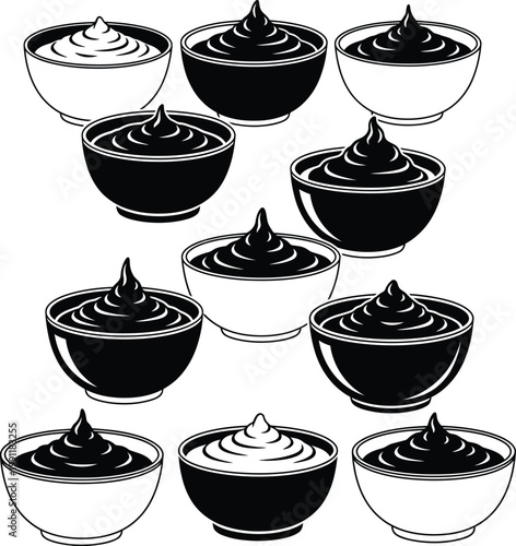 Black and white bowls of yogurt or pudding dessert food