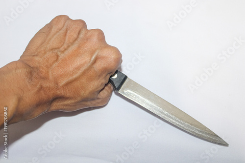 Tight grip holds a knife, sharp and ready
