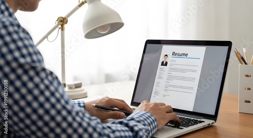 Person writing cv resume on laptop in home office with human resources, business