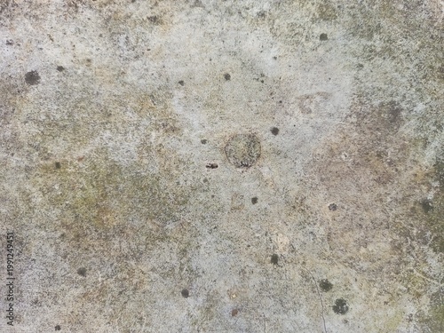 Grungy cement surface with dark spotted texture