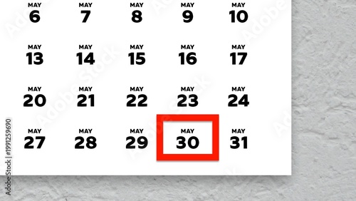 Close-up of the date May 30th marked with a red cursor on the wall calendar 2026