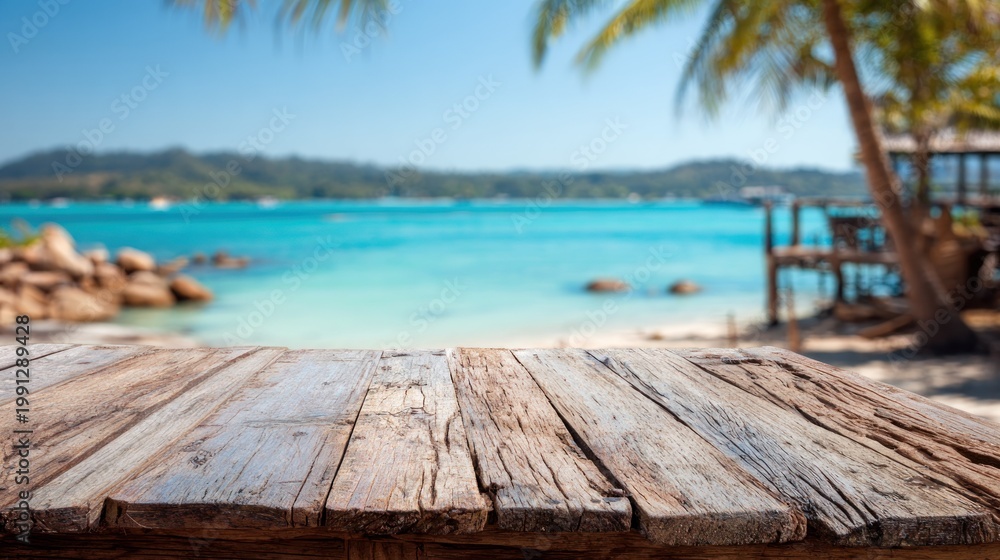 Fototapeta premium Wooden table with ocean and tropical island background vacation concept