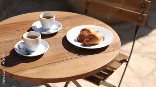 Coffee and Croissants on Wooden Table Outdoors.