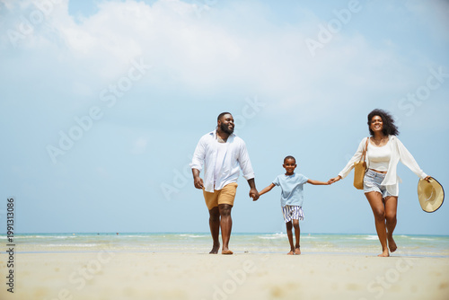 Billede på lærred Happy Black Family Holding Hands Walking on Sunny Summer Beach