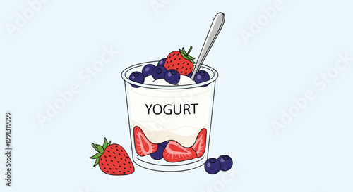 Healthy breakfast bowl of creamy white yogurt topped with fresh strawberries and blueberries in a transparent cup with a silver spoon.