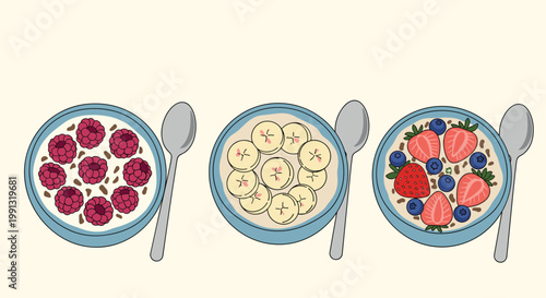 Delicious and healthy breakfast bowls of oatmeal topped with fresh raspberries, sliced bananas, and juicy strawberries with silver spoons.