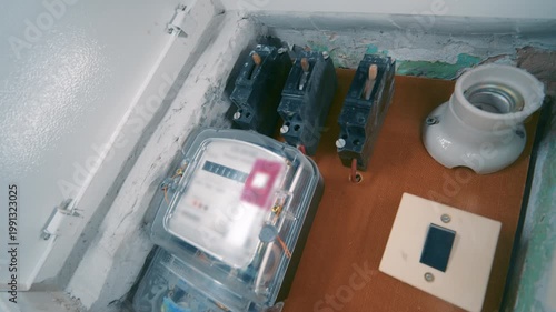 Old Residential Electric Panel Interior with Meter, Circuit Breakers and Socket | Slow Camera Move Dutch Angle Shot of Home Fuse Box | Vintage Electrical Installation Indoor