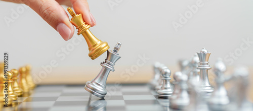 Tableau sur toile hand moving gold Chess King figure and Checkmate opponent during chessboard competition