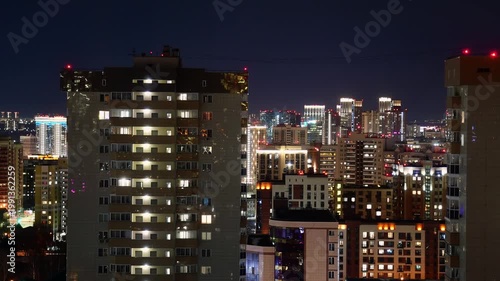 Timelapse of windows turning on and off in a modern apartment building at night. Urban scenic view