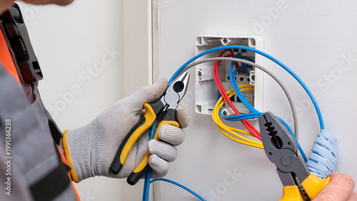 Quadro em tela ​An electrician holds yellow-handled pliers