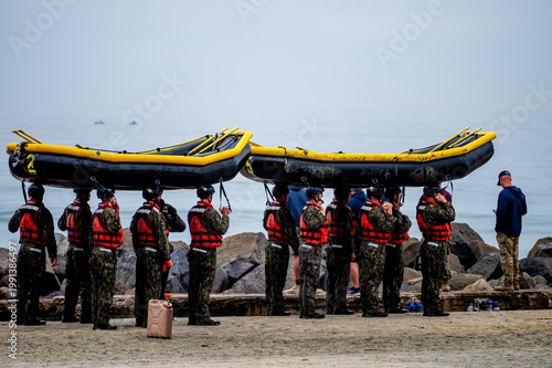 U.S. Navy SEAL candidates carrying inflatable boats on heads during BUD/S training