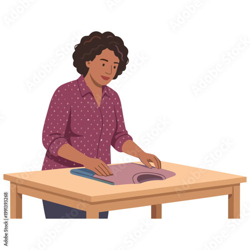 Woman cutting fabric on a table with scissors.