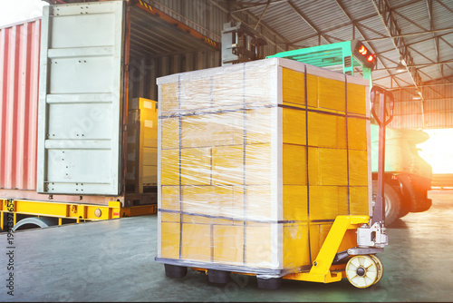Bulk of package boxes shipment. Goods awaiting loading into containers trucks. Carton, CardBoard Boxes. Distribution Warehouse, Shipping Cargo Container. Freight Transportation,Truck Logistics.