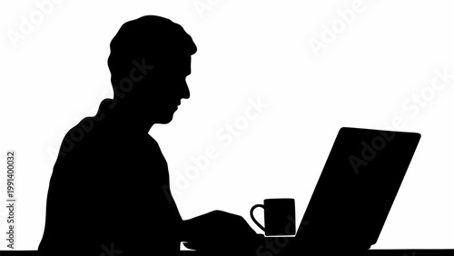 Man working late at night on laptop with coffee cup beside him in black silhouette