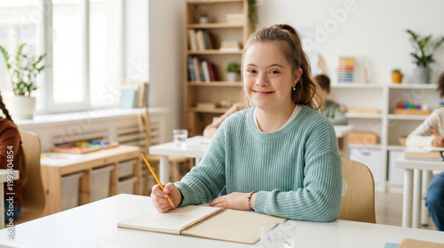 A young woman with Down syndrome studies with a notebook and pencil in a bright classroom or office, inclusive education, personal growth, lifelong learning.