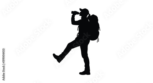 Silhouette of a hiker taking a break and drinking water outdoors