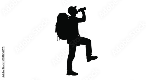 Silhouette of a hiker drinking from a water bottle during a trek