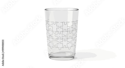 A clear glass with puzzle piece design sits on a white surface.