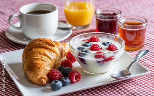 Delicious continental breakfast with fresh croissant and yogurt with berries