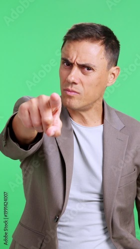 Angry businessman pointing his finger at camera