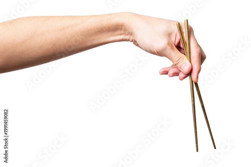 isolated of a man's hand holding a golden chopstick with a clipping path.