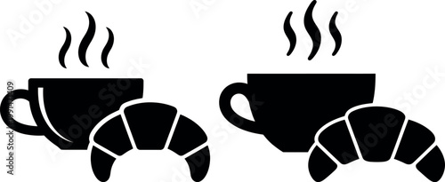 Two cups of steaming coffee paired with freshly baked croissants