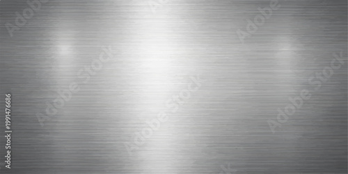 Polished silver brushed metal texture featuring a shiny stainless steel plate surface with a grey industrial aluminum pattern and metallic reflection on an alloy material sheet backdrop