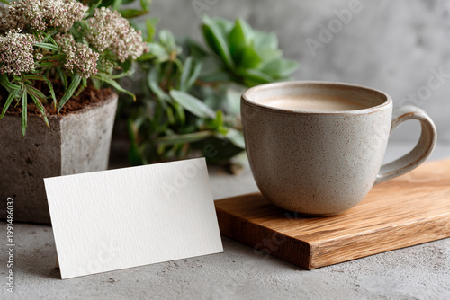 A steaming white ceramic cup of hot espresso sits beside a blank notebook on a rustic brown wooden cafe table during a quiet morning breakfast