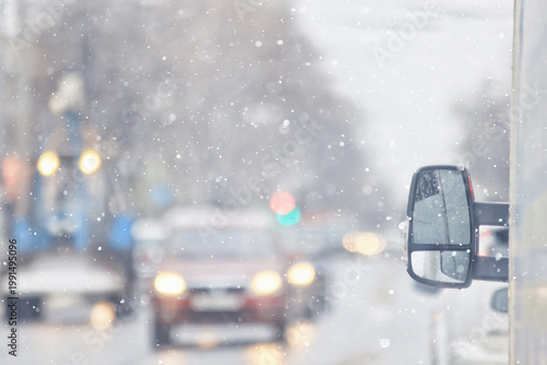 Snowfall on a city highway, blurred background, transport in winter weather, cars