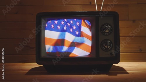 Vintage Television with US flag waving in living room with wooden background. 