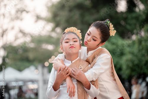 Smiling Women in Traditional Attire with Orange Flowers in Hair