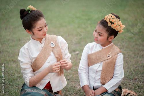 Traditional Asian Women in Cultural Dress Enjoying Nature Together