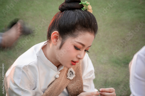 Young Woman in Traditional Costume Engaged in Artistic Crafting Activity