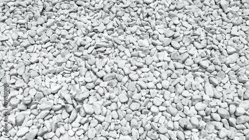 Bild auf Leinwand Close up view of numerous small white decorative stones creating a detailed natu