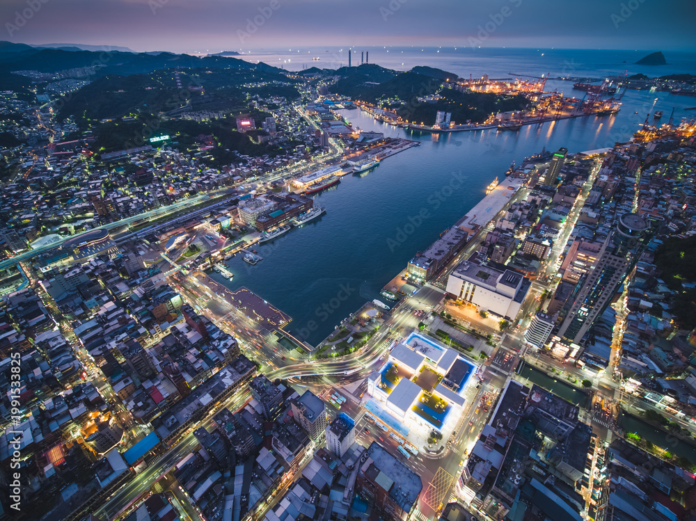 Naklejka premium Aerial View of Keelung City Skyline - Port city concept image. Panoramic cityscape birds eye view use the drone in evening, major port city situated in the northeastern part of Taiwan.