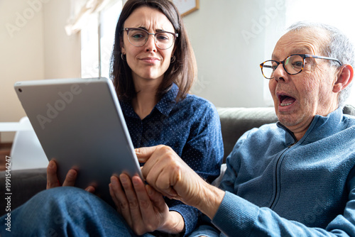 Senior man and woman discovering new digital tablet content